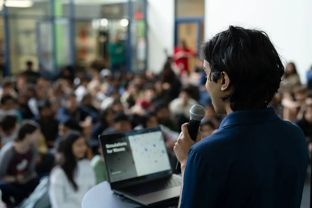 Student giving a presentation to a large group