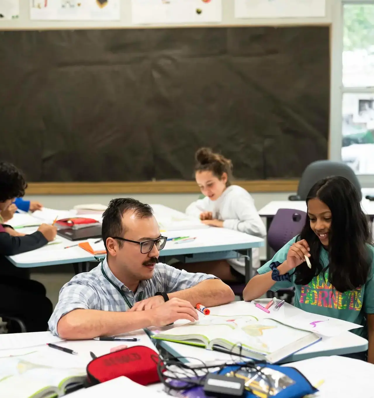 Teacher working with students