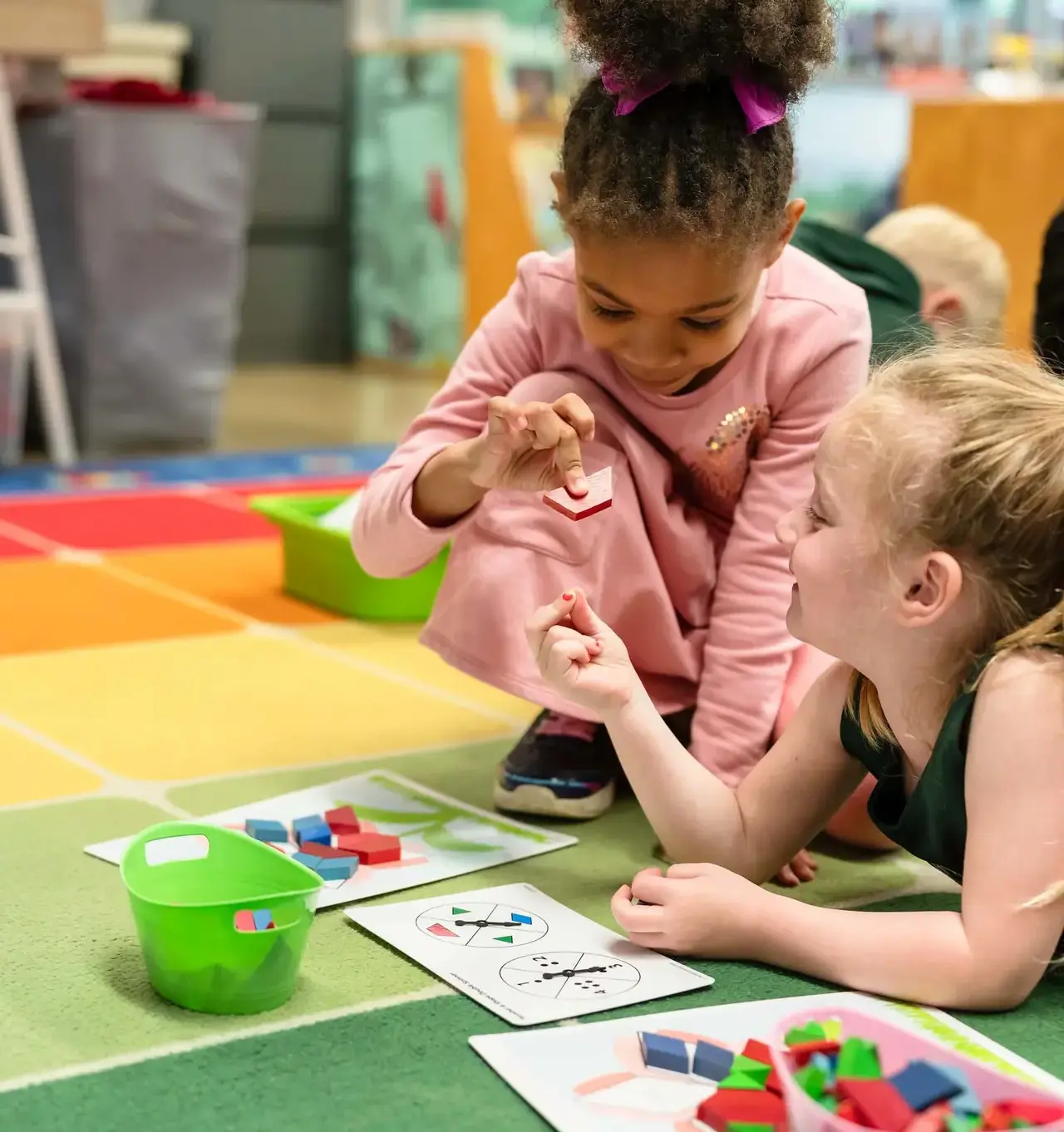 Two girls using manipulatives