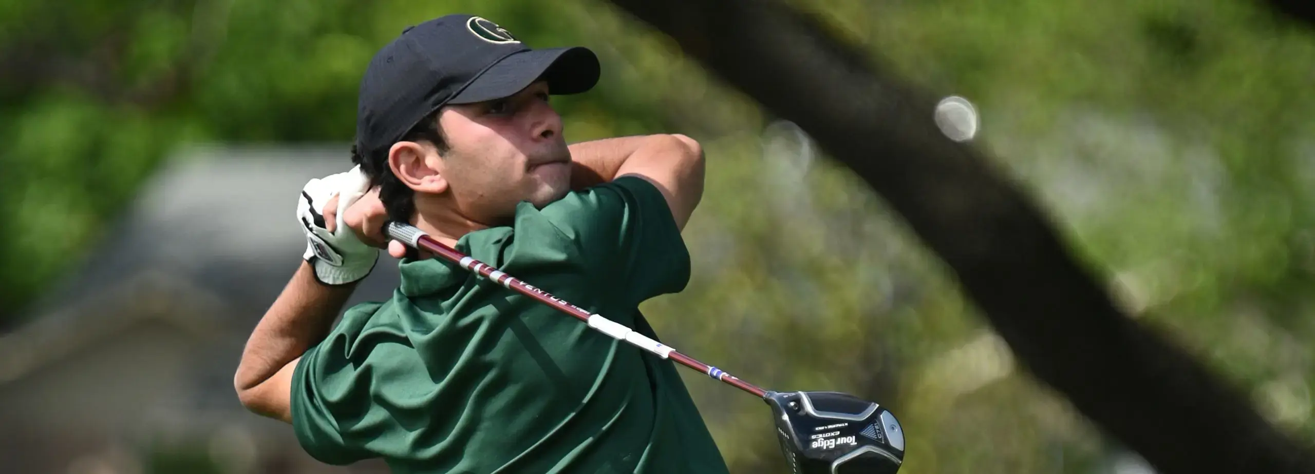 Boy teeing off on golf course