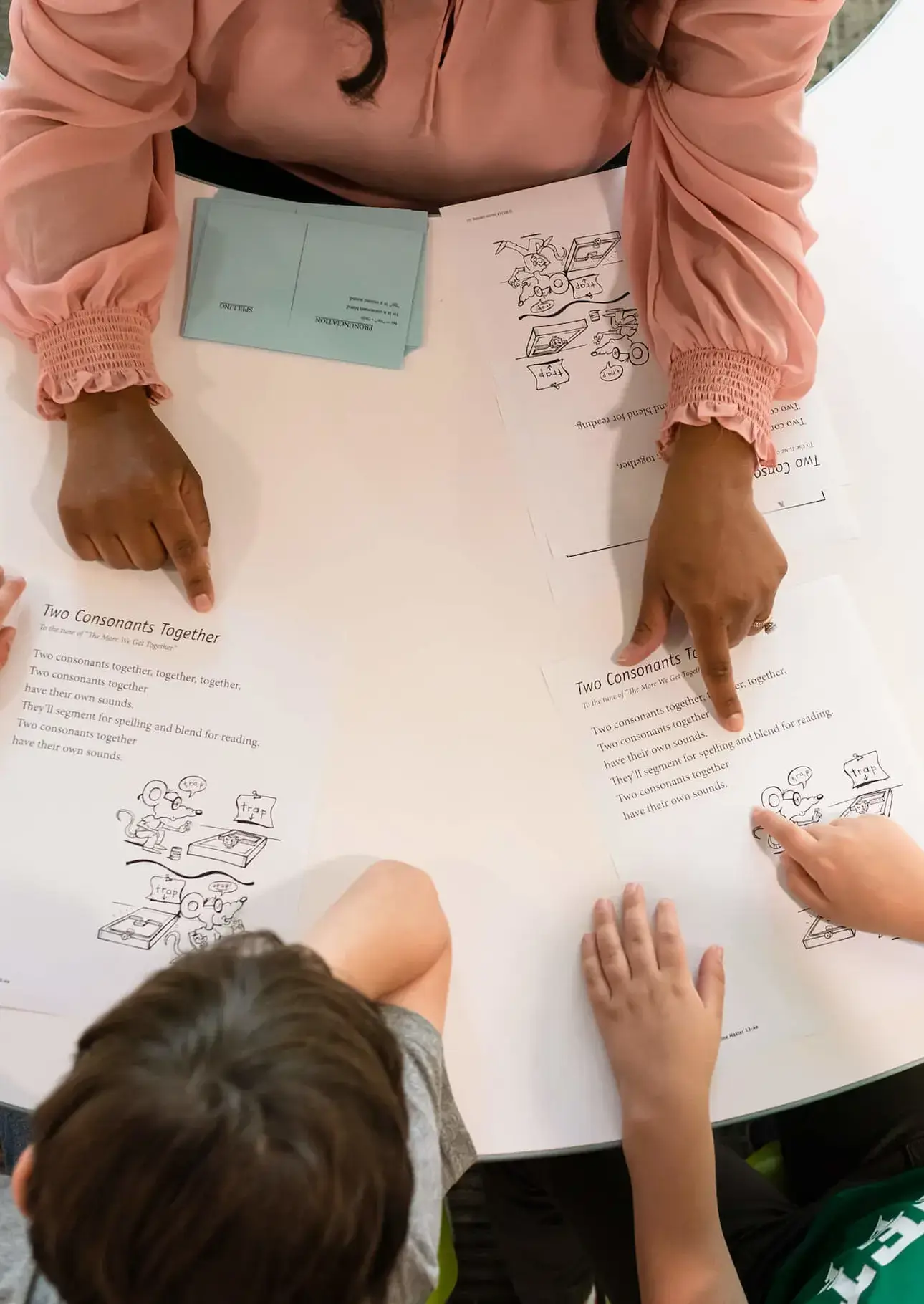 Teacher and students working at table