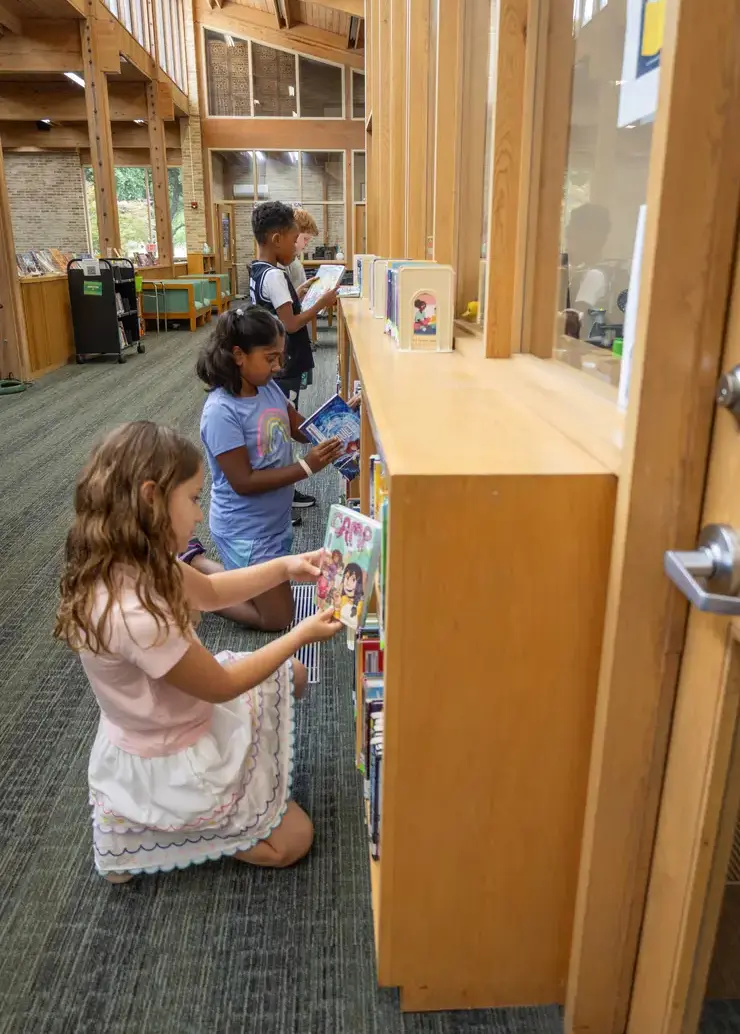 Students looking for a book in the library