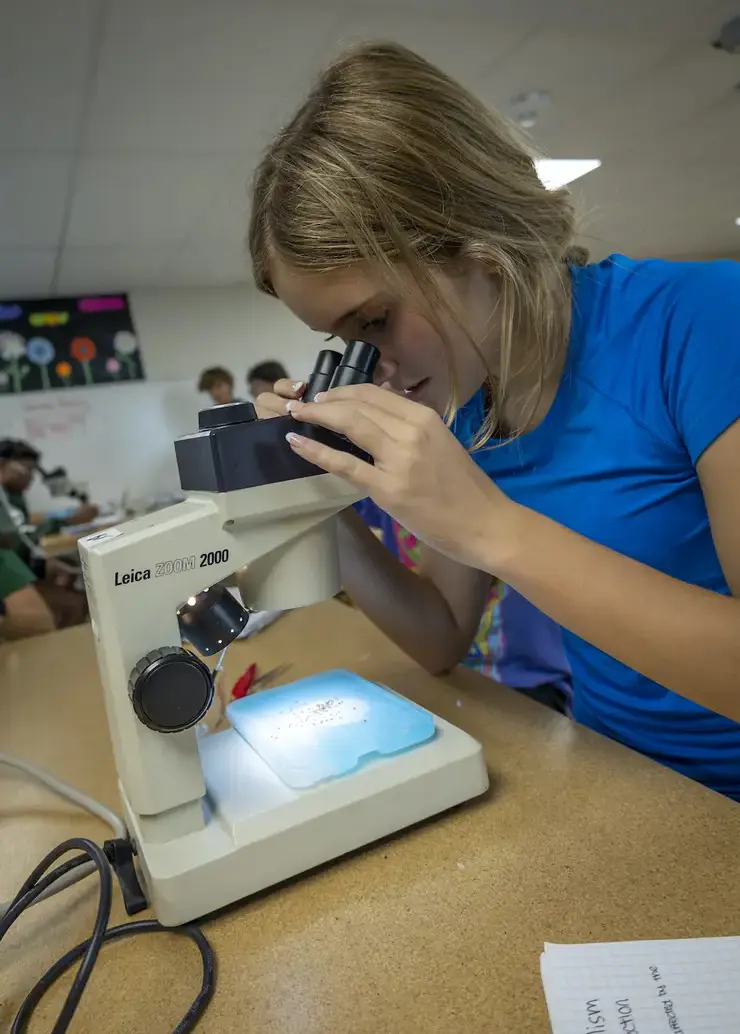 Student looking into a microscope