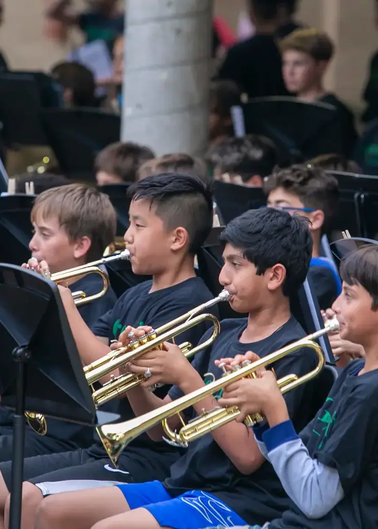 Student playing trumpet outside