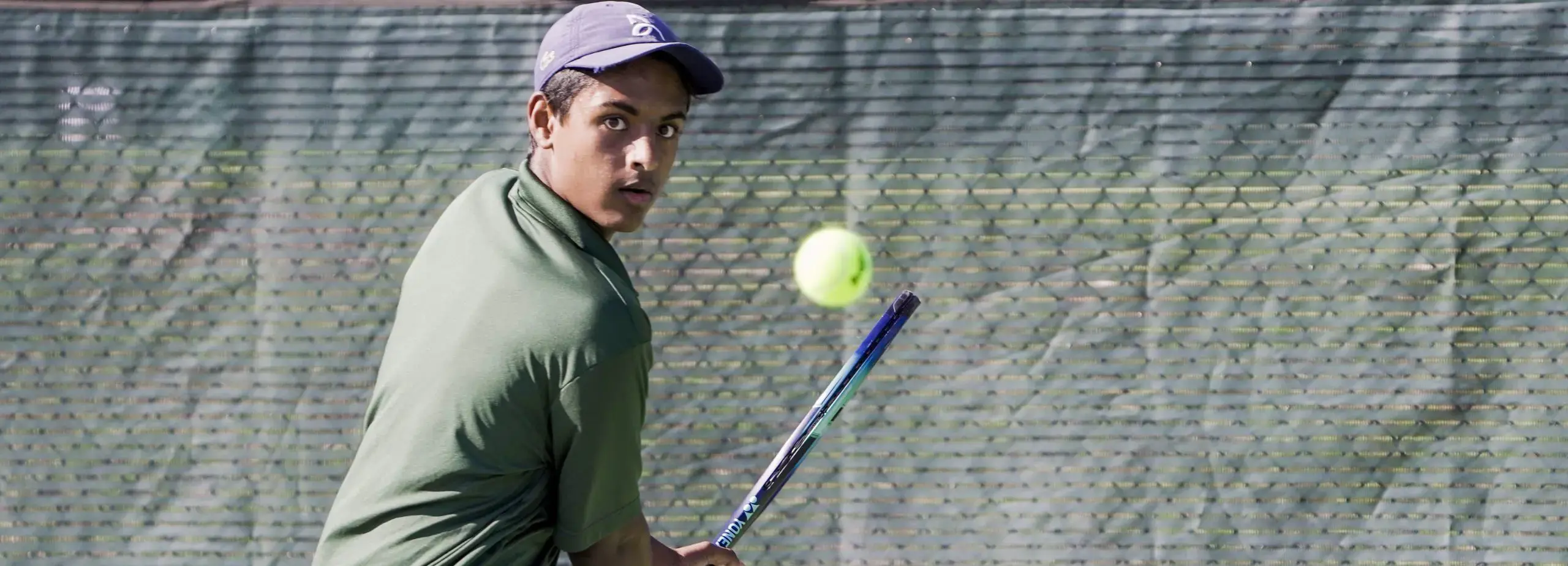 Boy hitting tennis ball