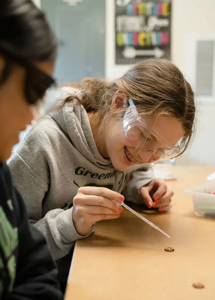 Upper School Student using a pipette 